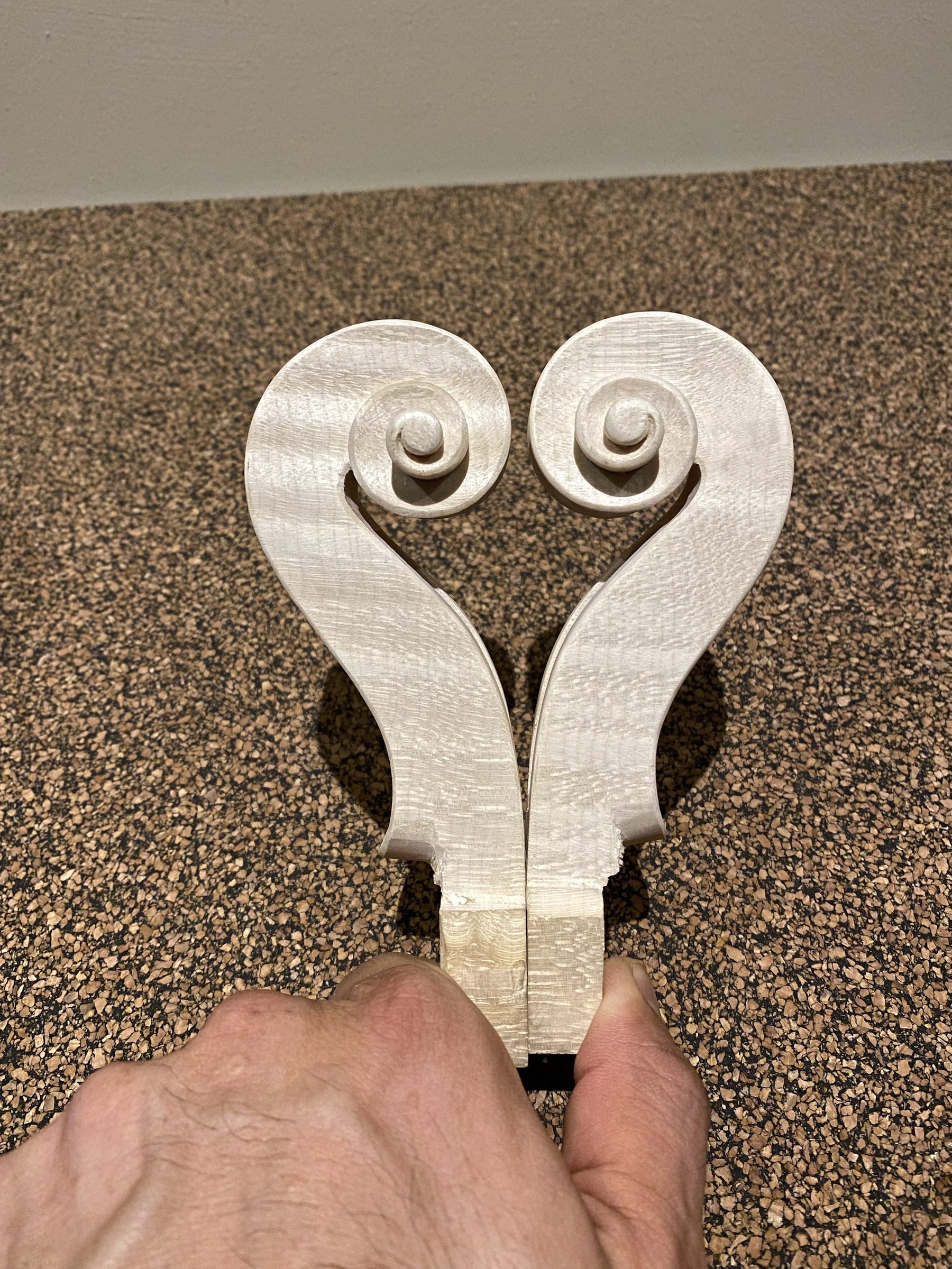 A pair of scrolls in the white, shaped like a heart