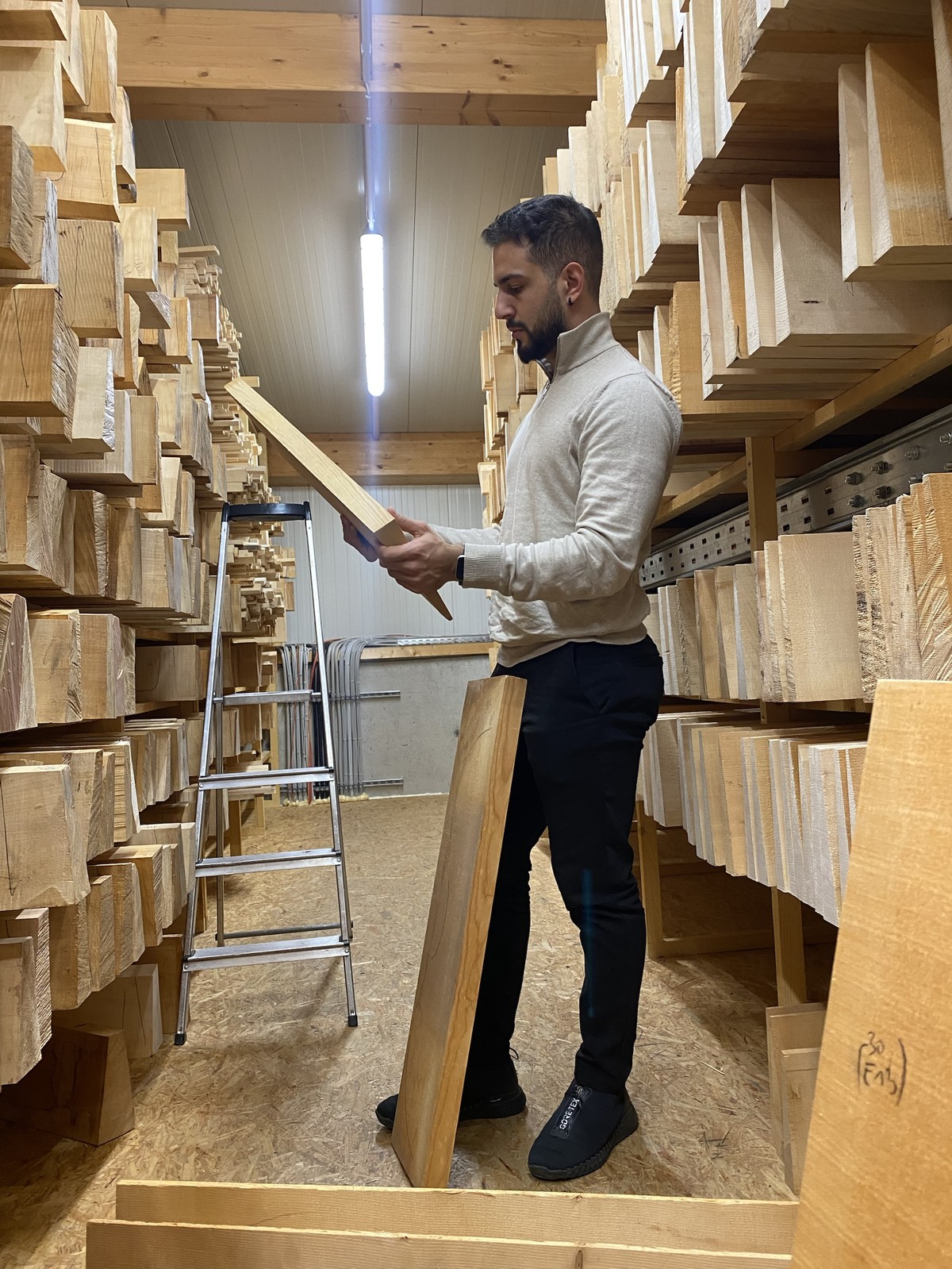 Marios selecting a piece of tonewood in the wood store