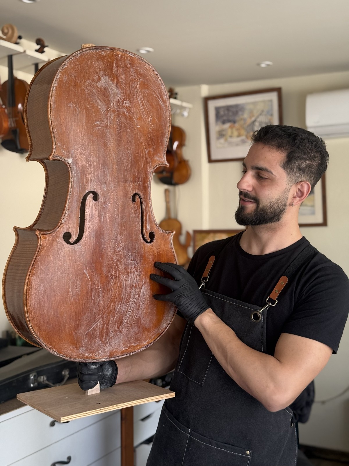 Applying the ground coat to the cello back
