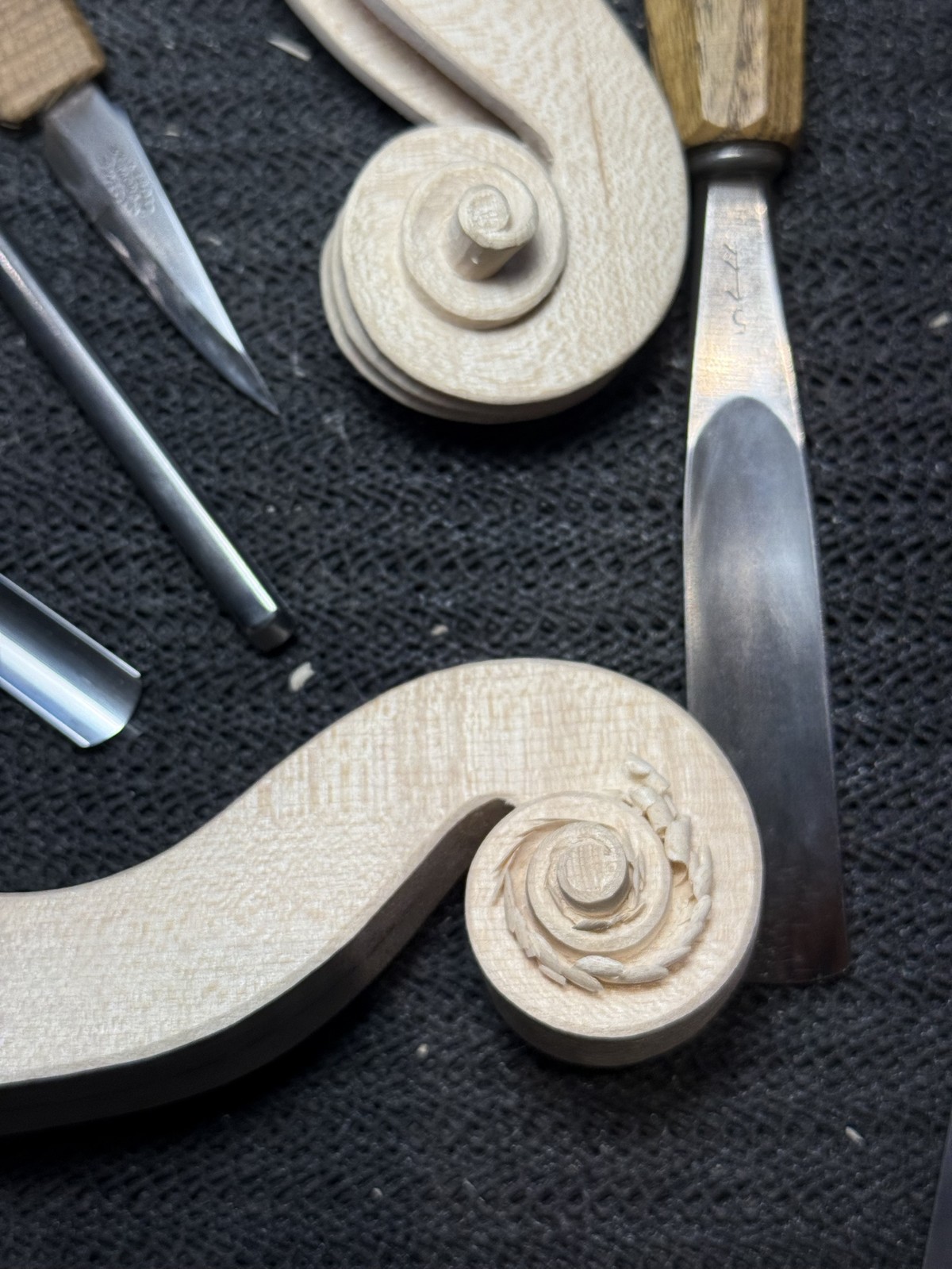Two scrolls at different stages of carving