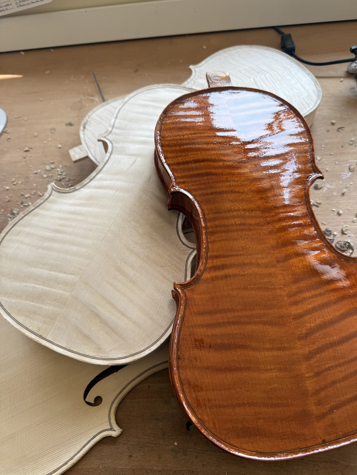 A varnished back beside two still in the white