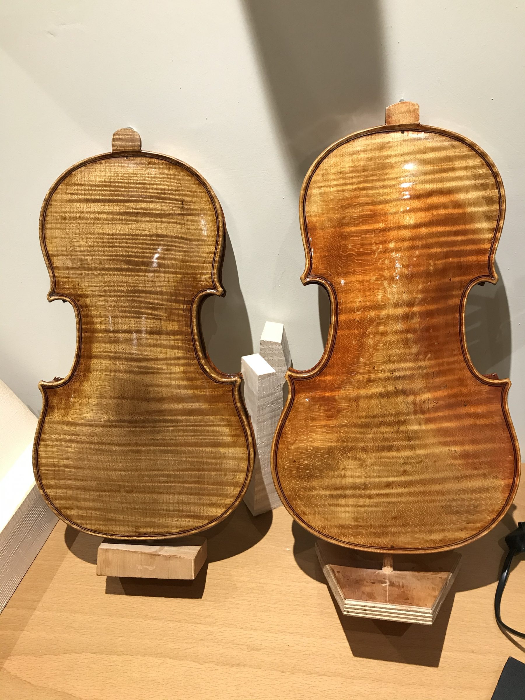 Two Stradivari model violin backs, one still in the white and one varnished