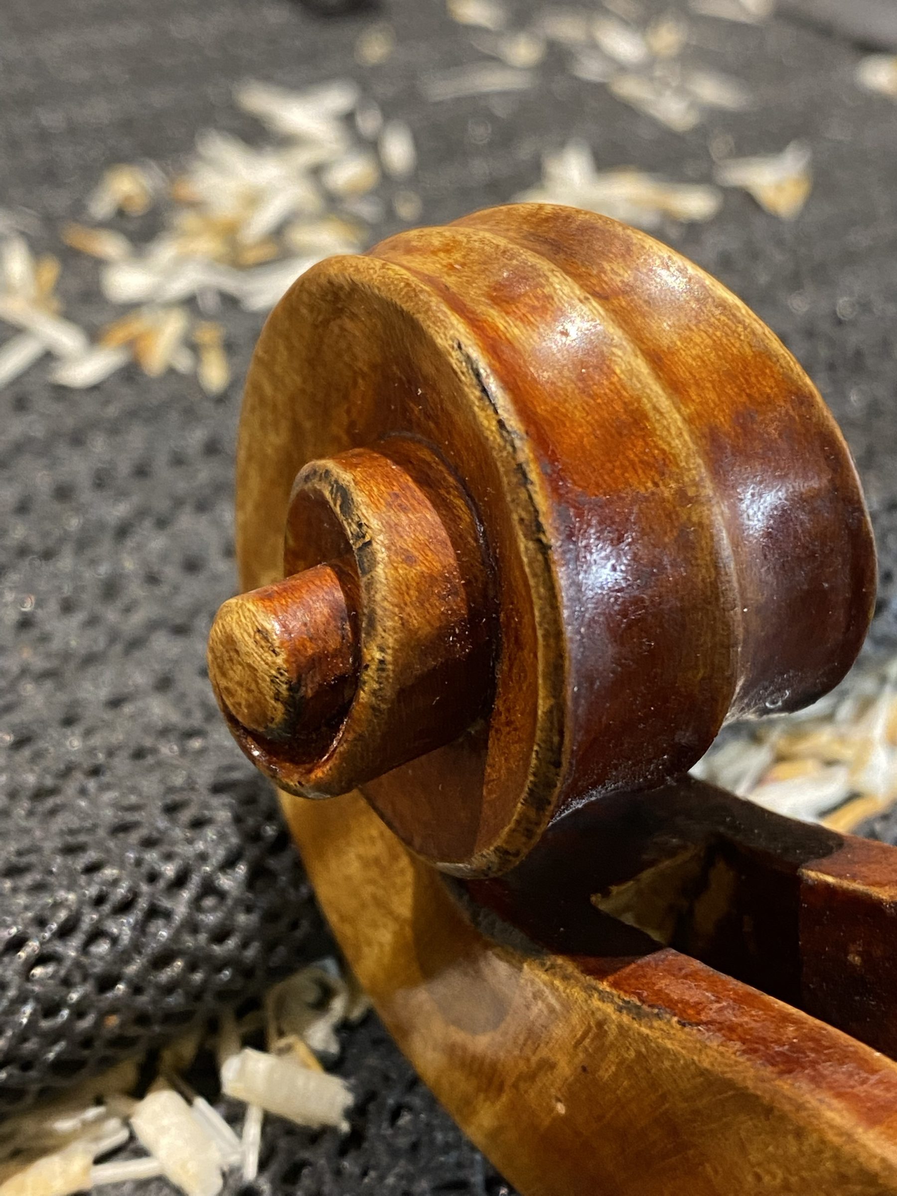 Stradivari model scroll on the workbench, among the shavings
