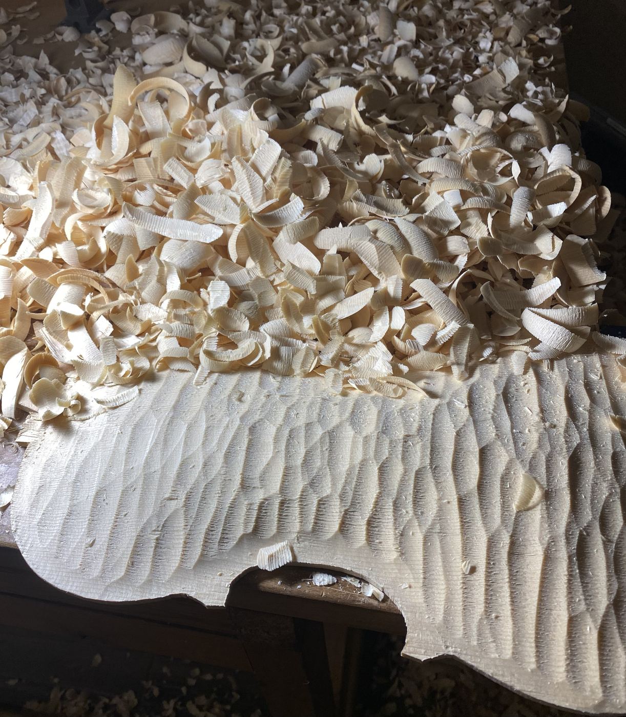Gouge work on a viola spruce top, shavings all around