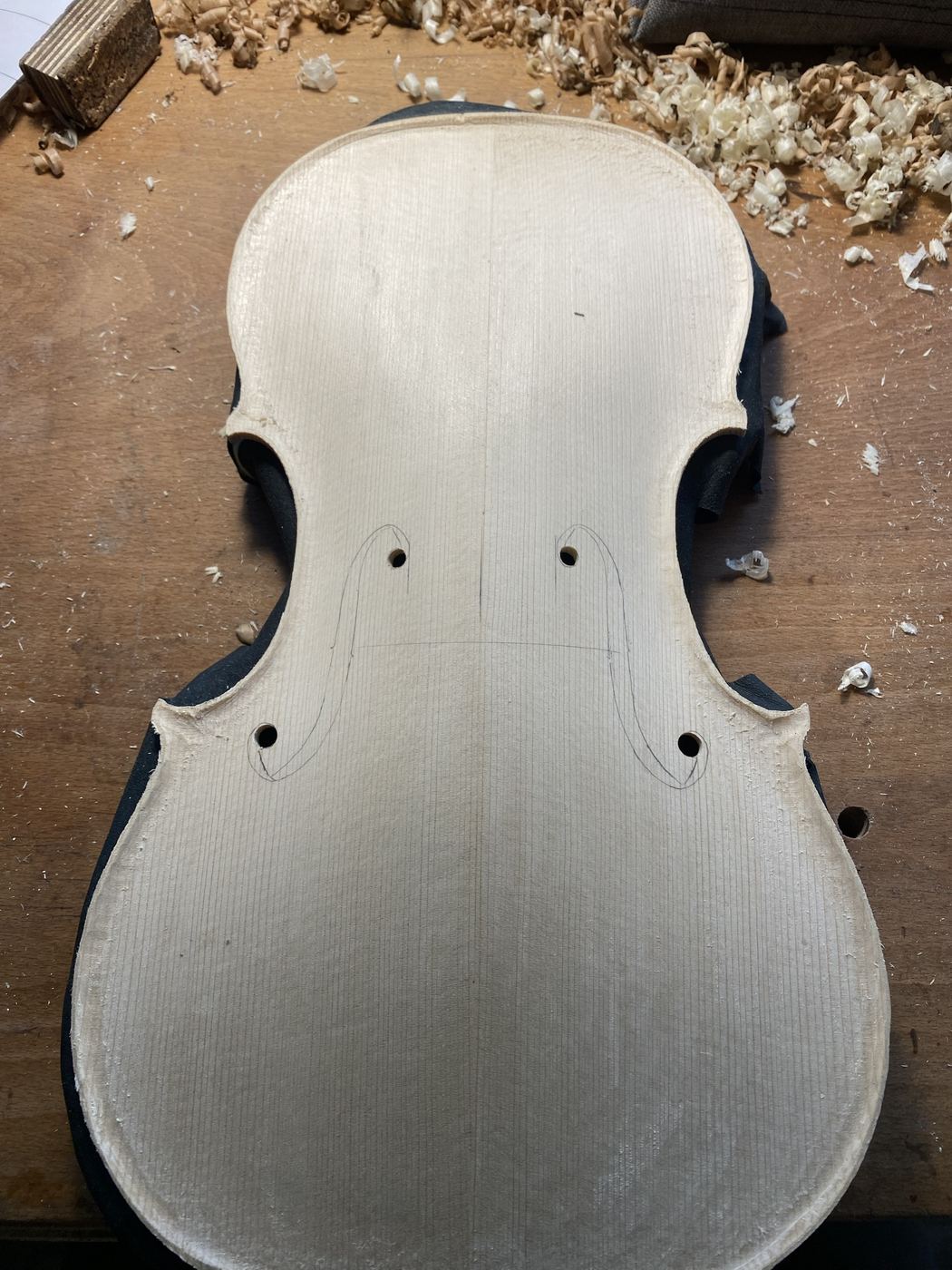 Viola top with the f-holes drawn and the drill holes made
