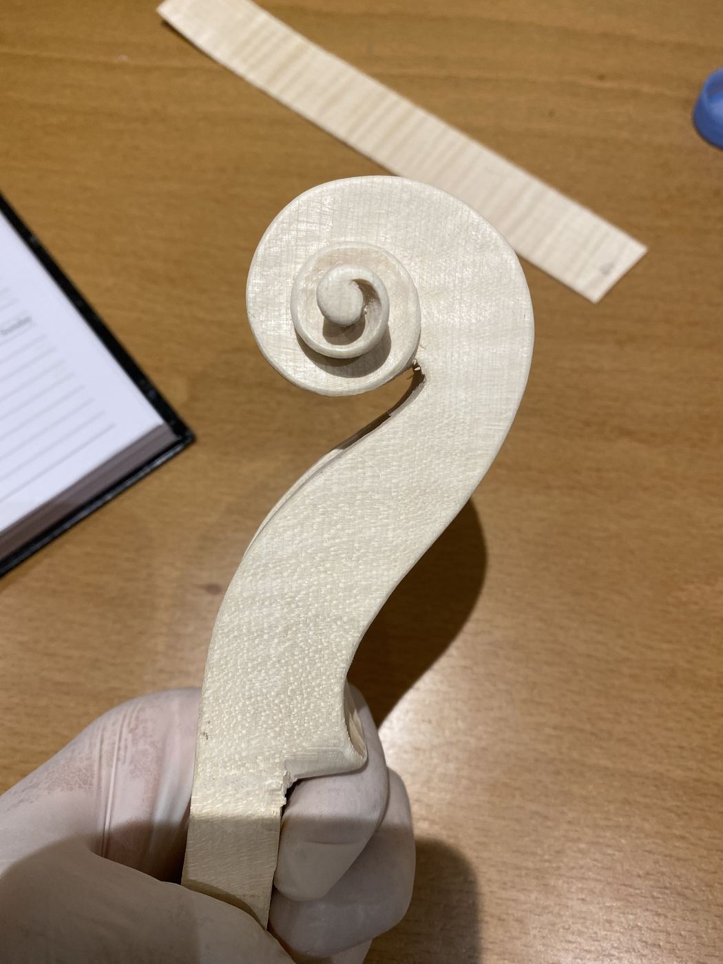 Carved viola scroll in the white
